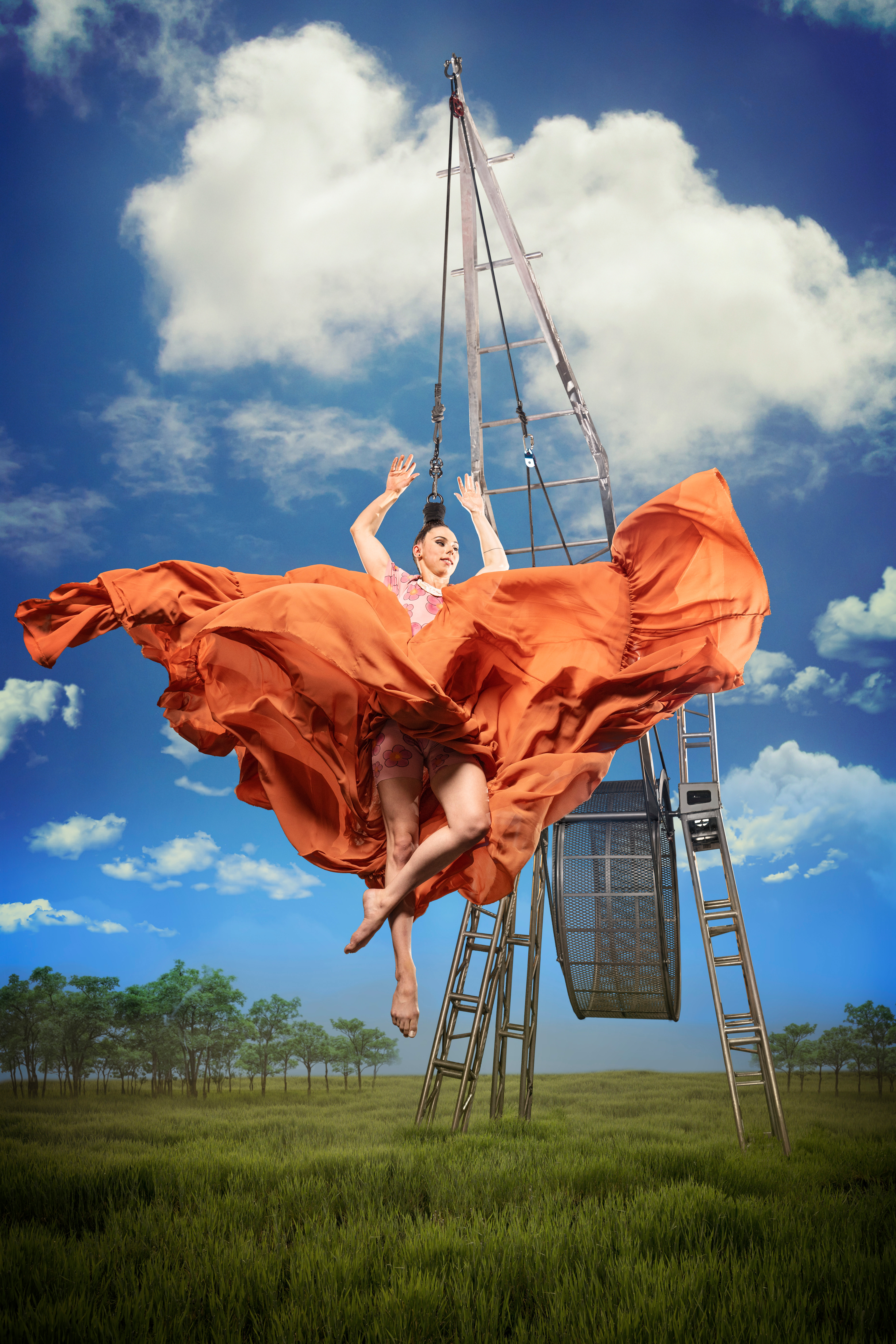 Photo of hair hanger in orange dress in a field.