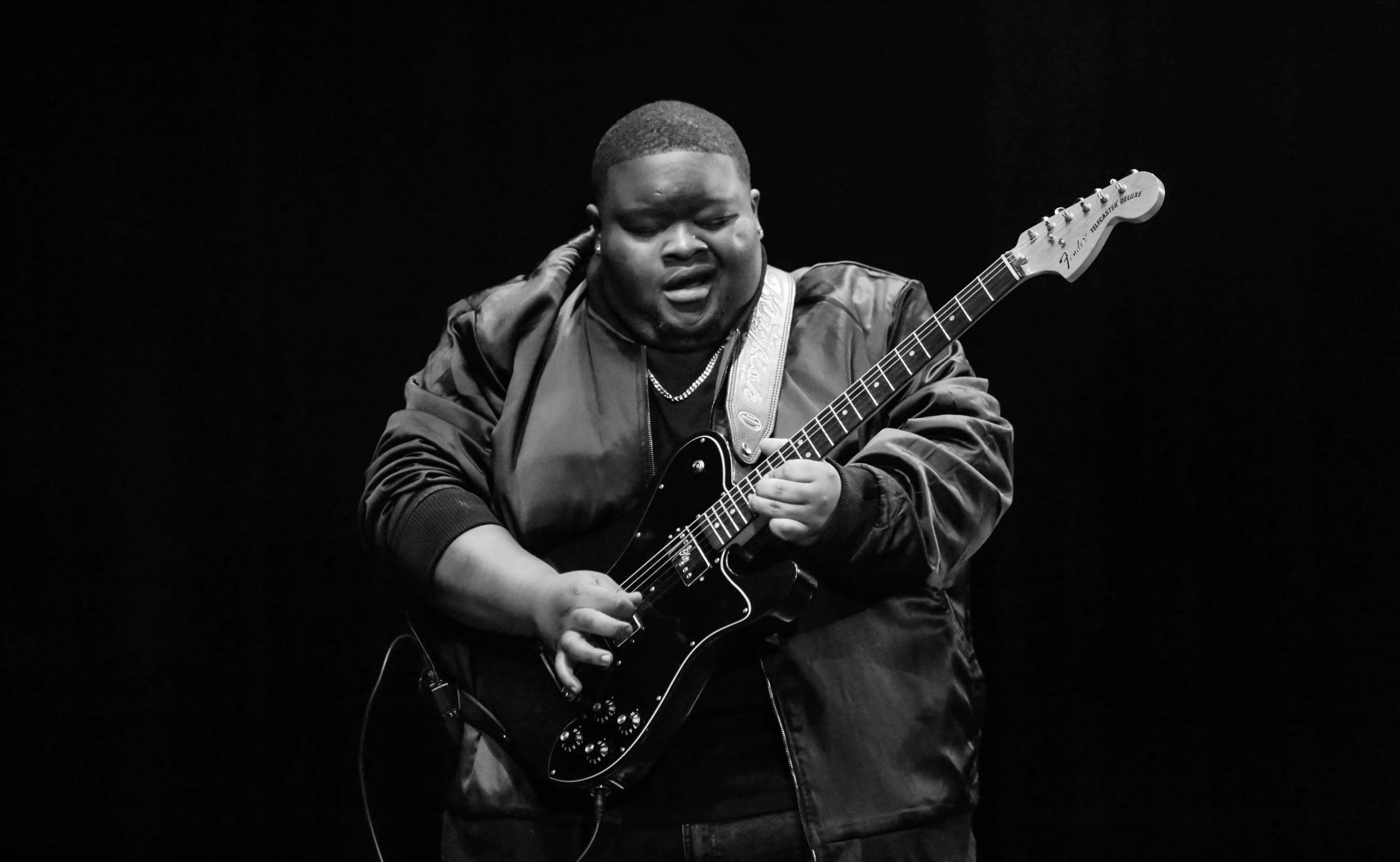 Black and white photo of Kingfish playing the guitar